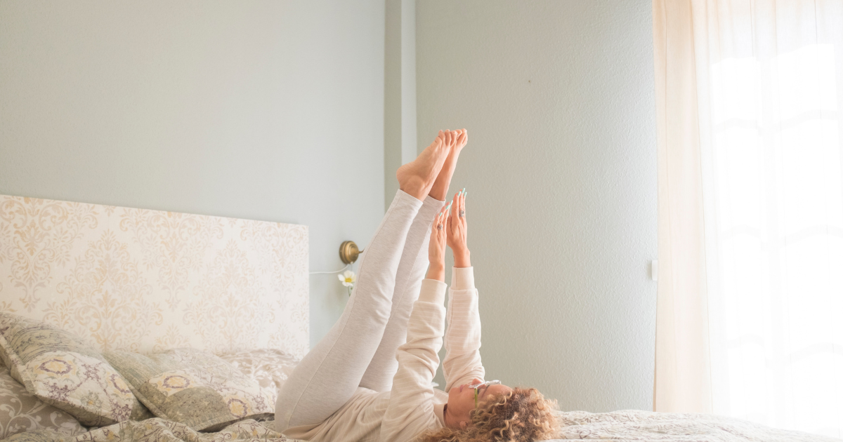woman doing bed pilates or bed workout