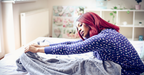 woman stretching in bed