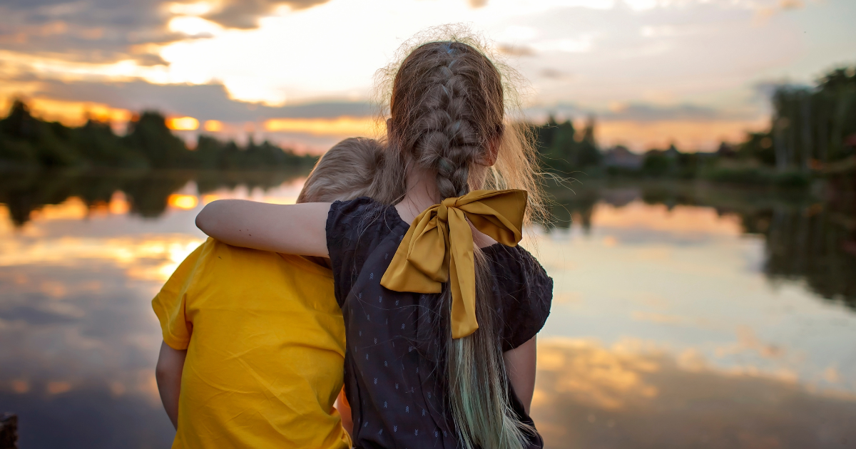 two children facing forward as a representation of the younger self